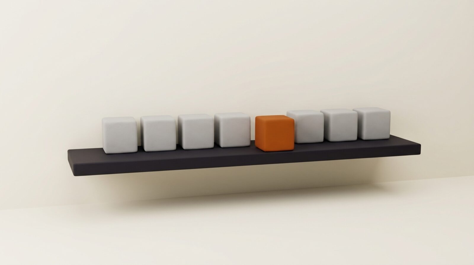 A single orange cube on a shelf among grey cubes