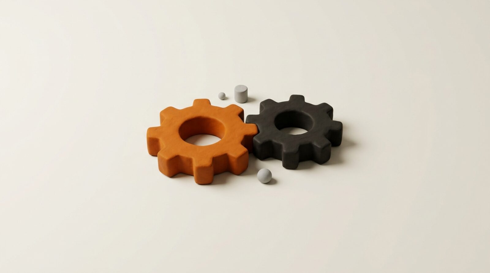 Two meshed gears, one orange and one black, turning together
