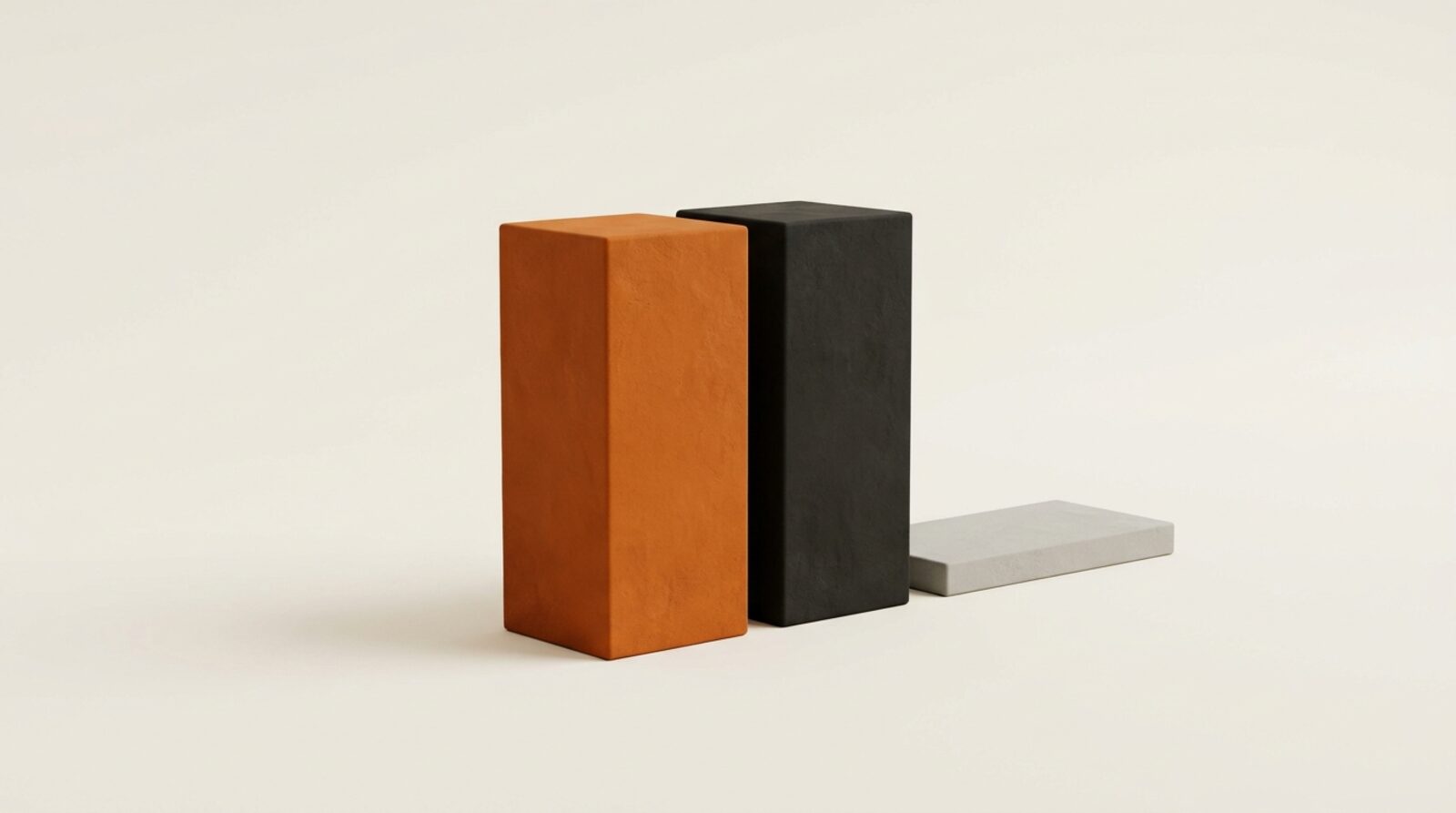 Two matte blocks rising together, one orange one black